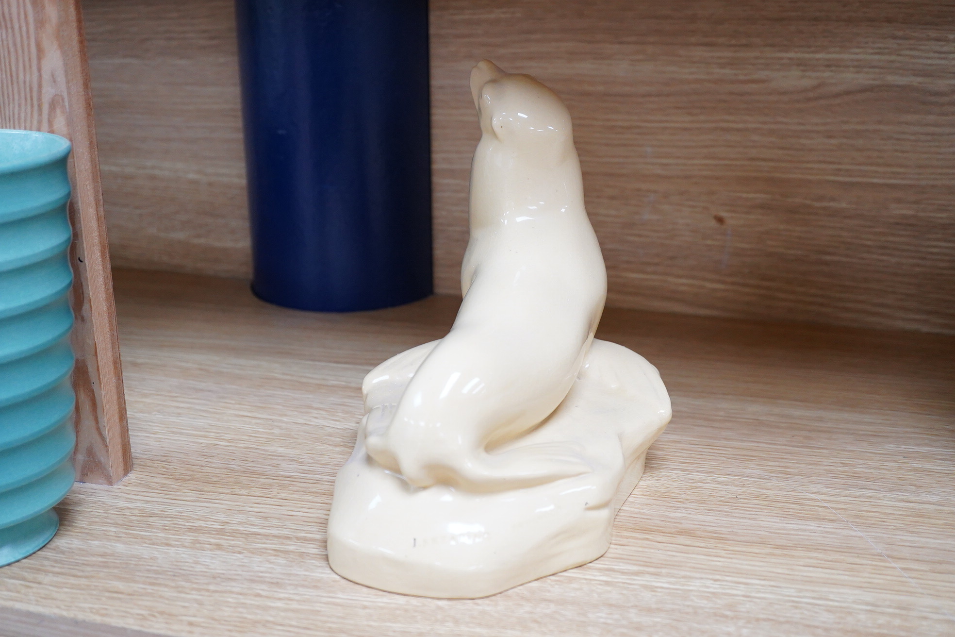 John Skeaping for Wedgwood, an Art Deco seal, straw glazed, 21cm wide